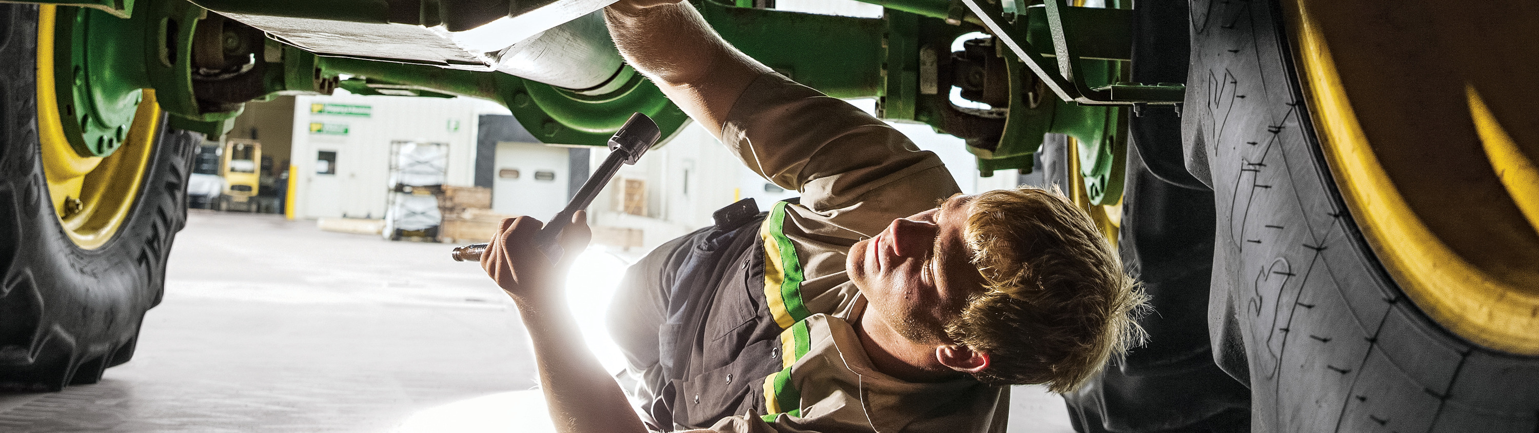 Man working on repairs on a piece of equipment at Sinclair Tractor's service department